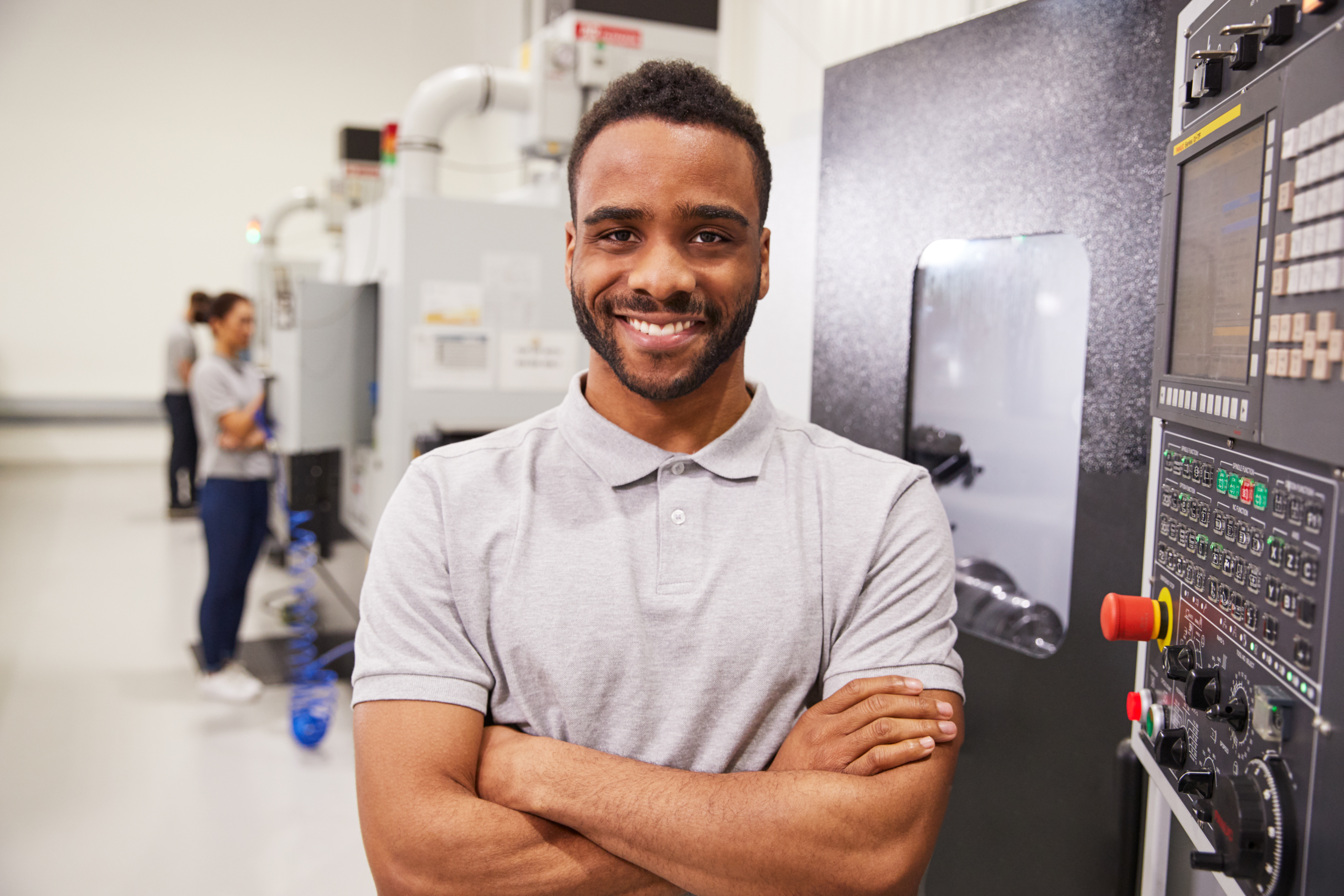 Male engineer in front of CNC machine